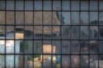 A print capturing an old cottage window in Southern Czechia, mirroring a mosaic of reflections through its unique square glass plates.