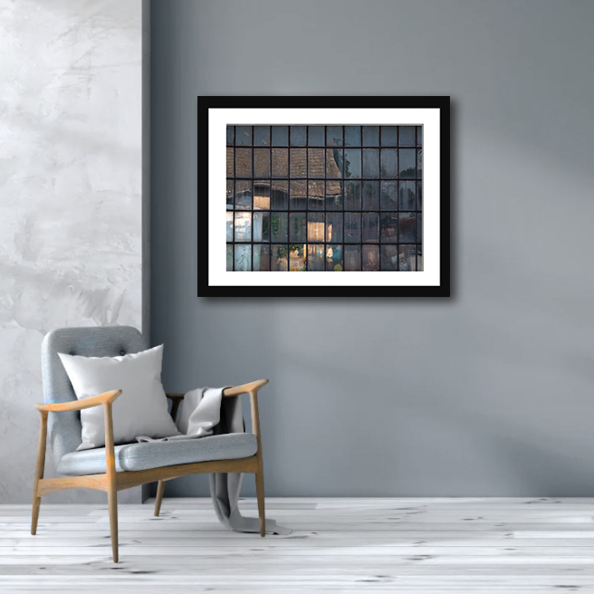 A print capturing an old cottage window in Southern Czechia, mirroring a mosaic of reflections through its unique square glass plates.