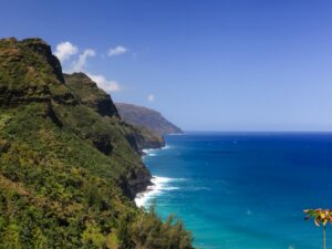 Experience the majestic Napali Coast, where towering mountains gracefully descend to meet the tranquil Pacific