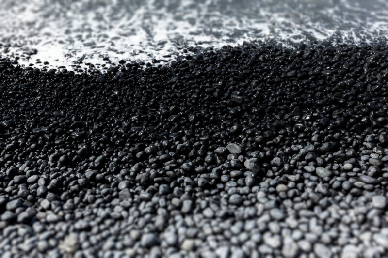 Discover the contrast of dry pebbles, the wet and the white surf in this depiction of the Oregon coast