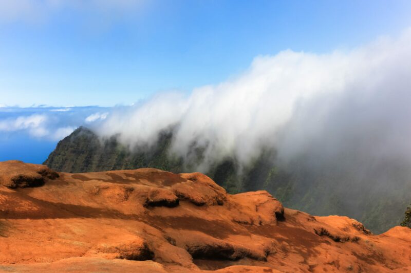 Experience a serene sky theatre as clouds dance gracefully over the majestic Koke’e Mountains, bringing a tranquil panorama alive in your living space.