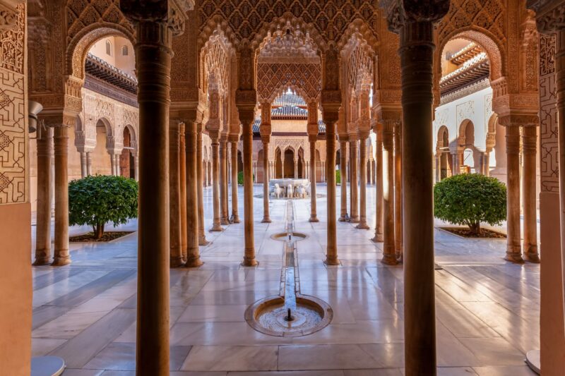 A captivating glimpse into the heart of Alhambra’s Nasrid Palace, embodying tranquility and architectural brilliance.