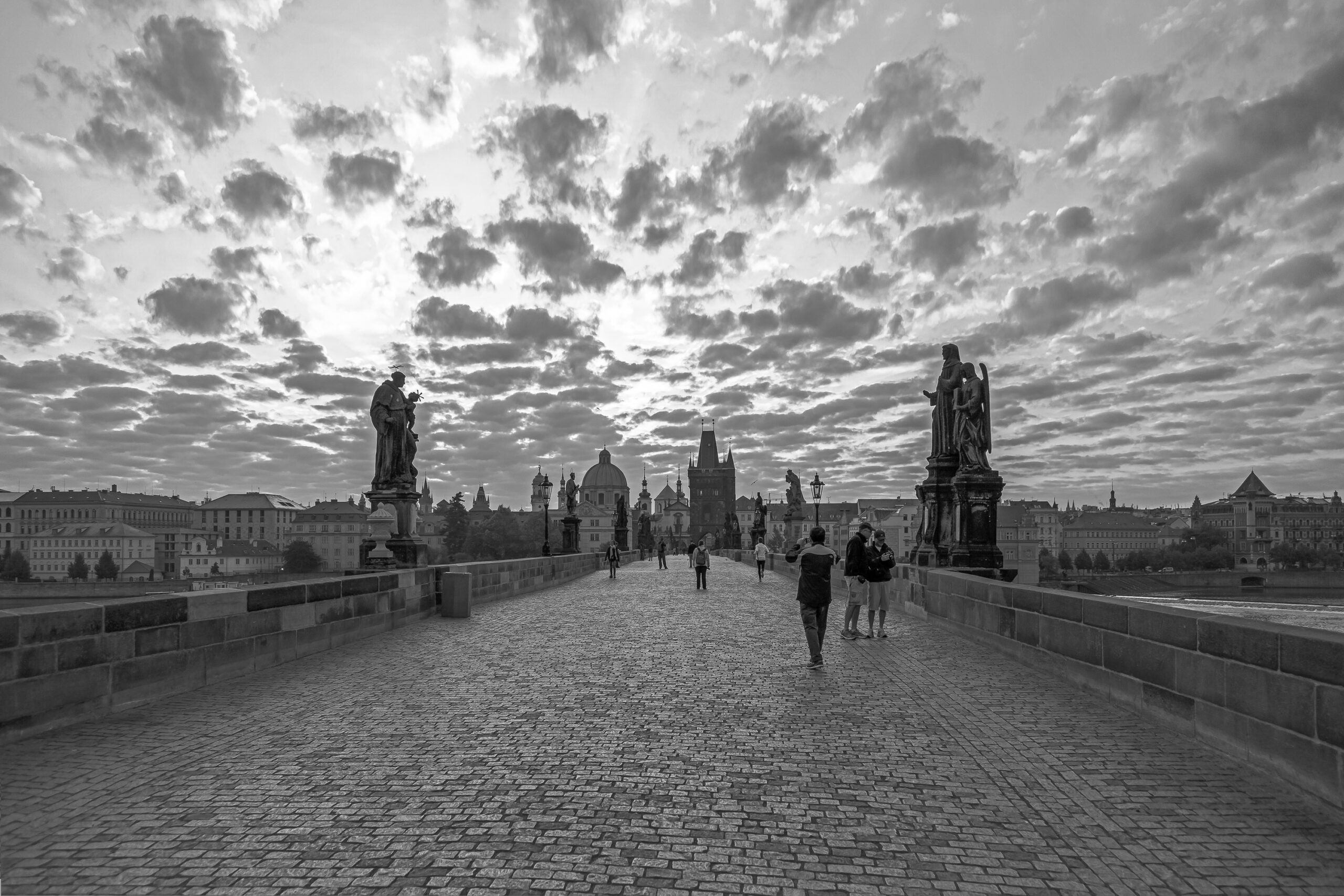 This print encapsulates the serene aura of Charles Bridge, Prague, during the early morning, showcased in beautiful black and white tones.