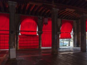 Immerse yourself in the calming yet vibrant ambiance of Venice, beautifully captured through the red hues of a picturesque warehouse that embodies tranquility and style.