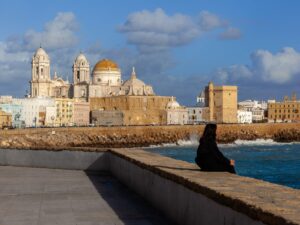 This striking image portrays a solitary figure amidst the historic beauty of Cadiz, offering a tale of reflection and timelessness.