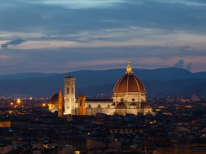 Evening view of Florence Duomo with city lights.