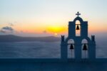 Sunset behind The Three Bells of Fira, Santorini.