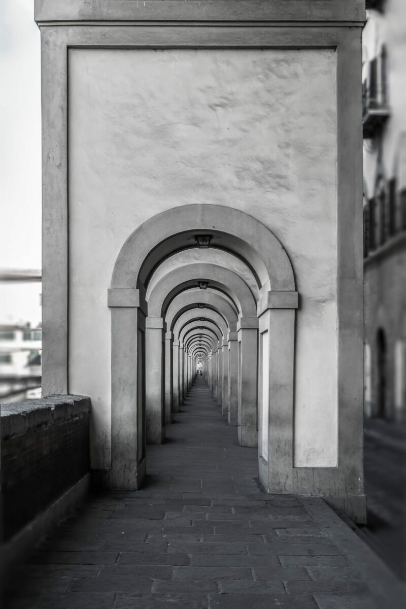 Monochromatic view of arched doorways in Florence.