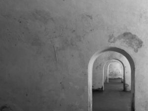 Black and white image of arched corridors in Castillo San Felipe del Morro.