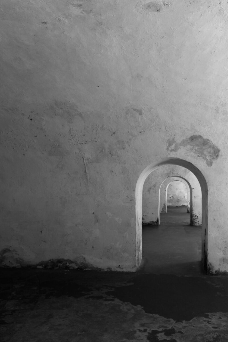 Black and white image of arched corridors in Castillo San Felipe del Morro.