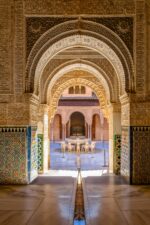 Detail-rich archways of Alhambra Palace with Moorish designs.