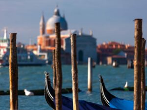 Venetian gondola with historic basilicas in background