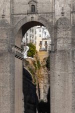 Ronda's iconic stone bridge with historic buildings backdrop