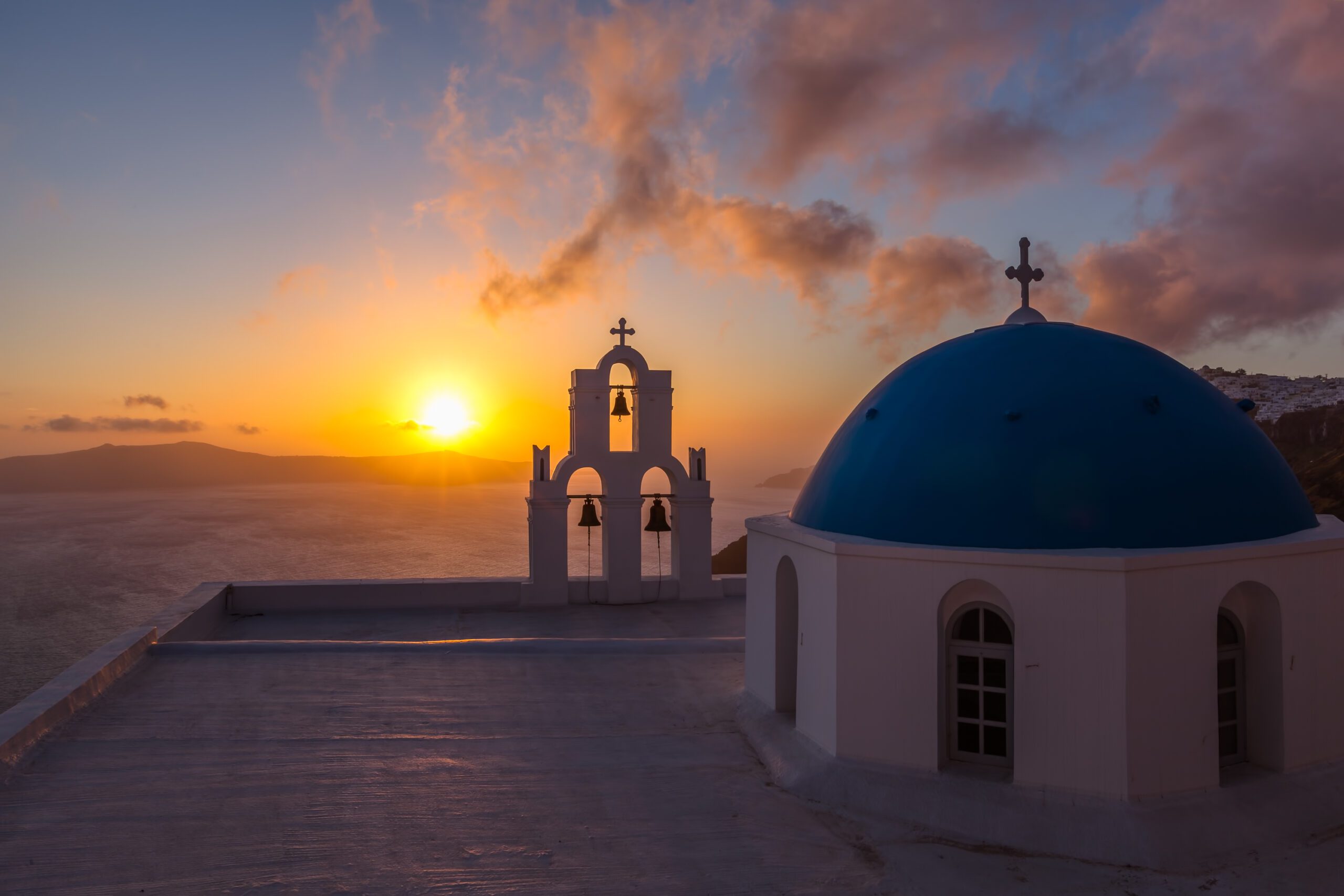 Santorini chapel at sunset with ocean view