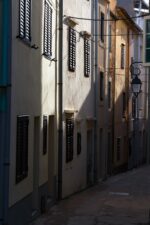 Sunlit streets of Vir with shadows on building facades