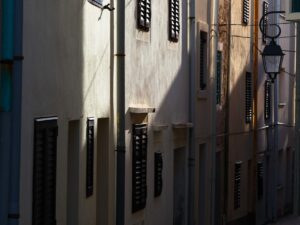 Sunlit streets of Vir with shadows on building facades