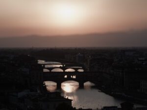 Florence bridges at sunset with glowing Arno River