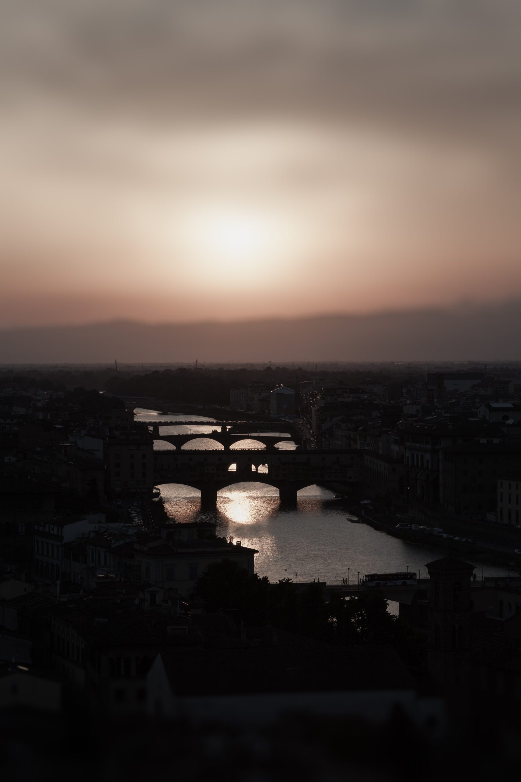 Florence bridges at sunset with glowing Arno River