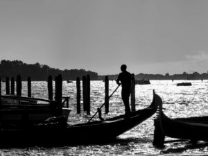 Gondolier silhouette against Venice sunset