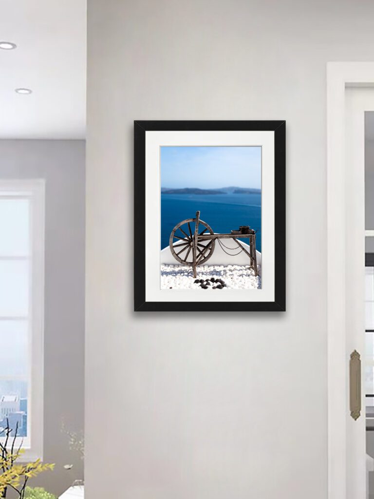 Old wooden spinning wheel overlooking the ocean in Santorini, Greece