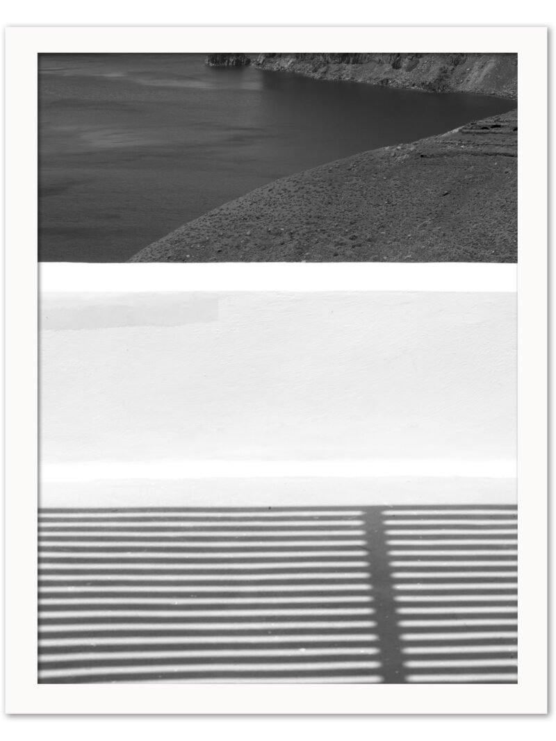 Dramatic geometric shadows cast across a balcony in Santorini, Greece.