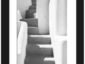 Black and white photo of an ancient staircase with shadows in Santorini, Greece.