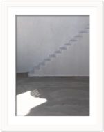 White staircase with shadow play in a whitewashed building in Santorini, Greece.
