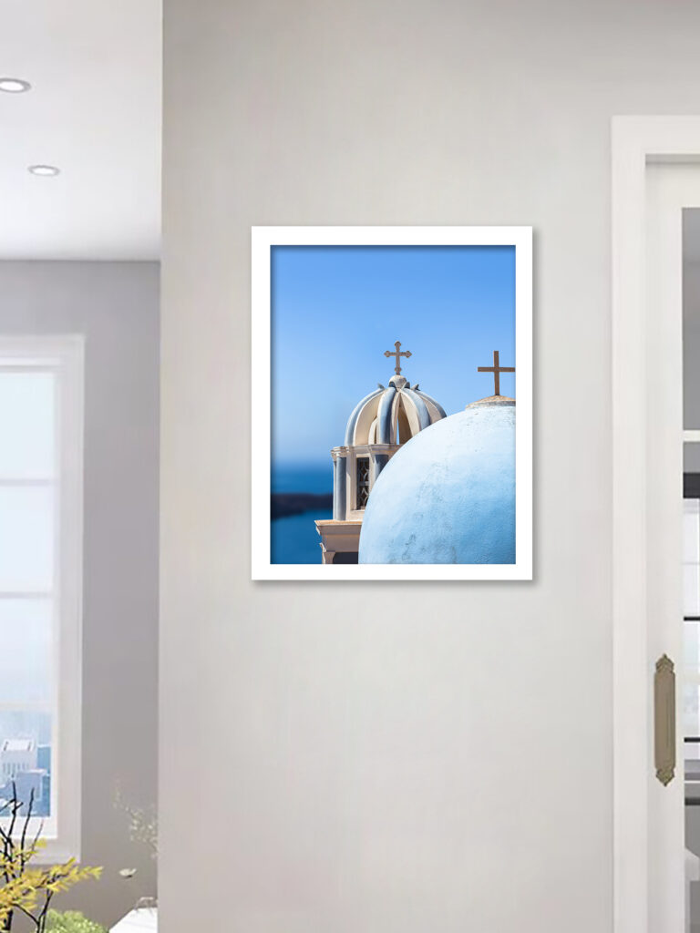 Iconic blue church domes under the clear sky in Santorini, Greece.