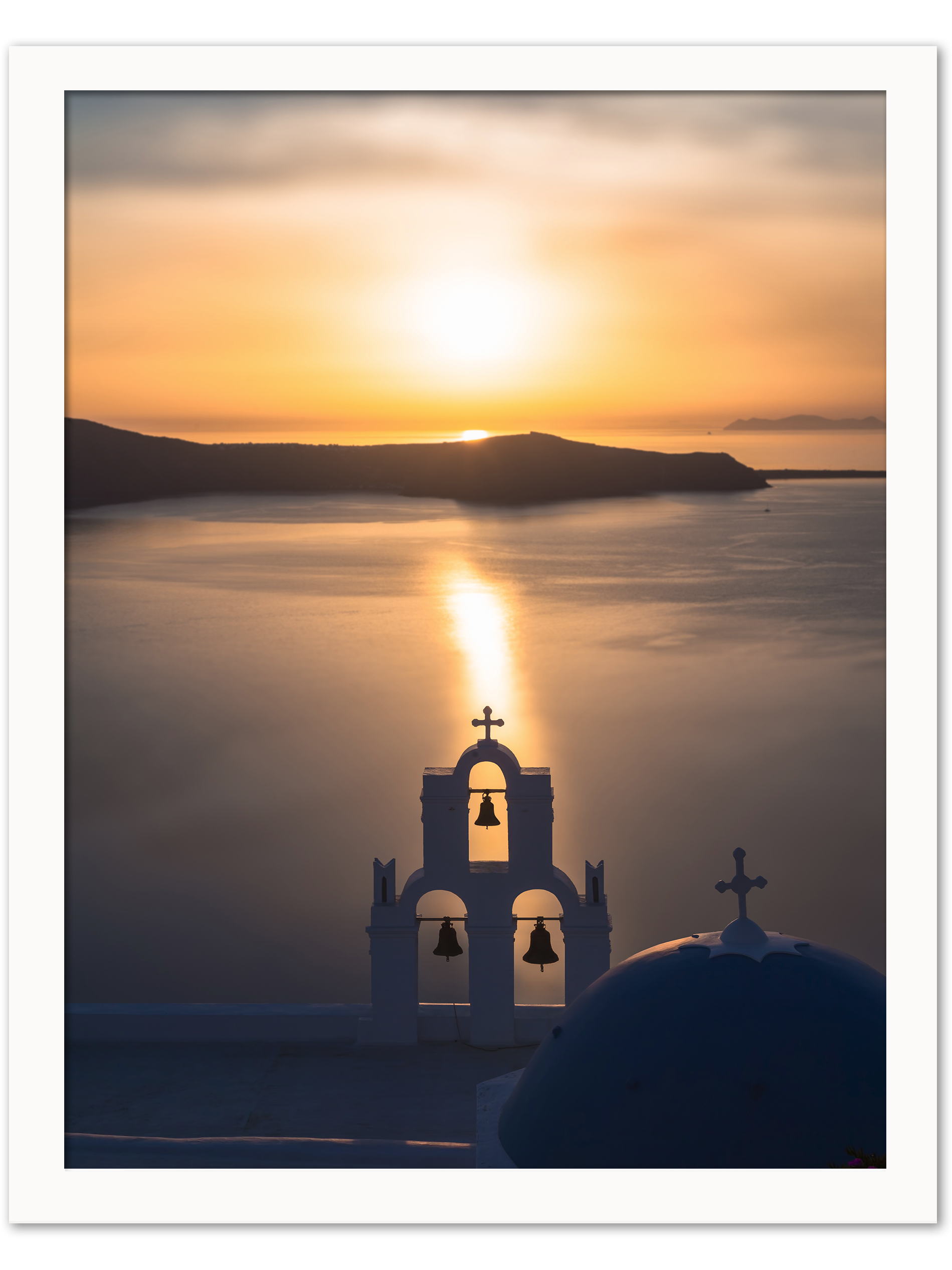 Church bells silhouette against a golden sunset in Santorini, Greece.