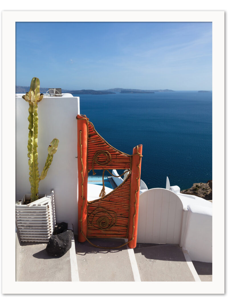 Vibrant orange gate in Fira, Santorini overlooking the clear blue caldera waters.